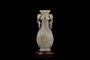 A CHINESE MUGHAL STYLE CARVED CELADON JADE ELONGATED VASE, China, Qing dynasty, 19th / 20th century