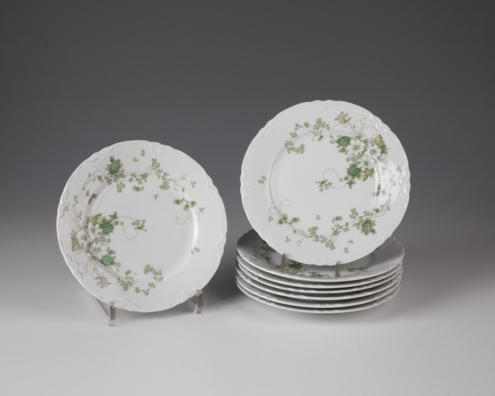 Eight plates with green vine decoration