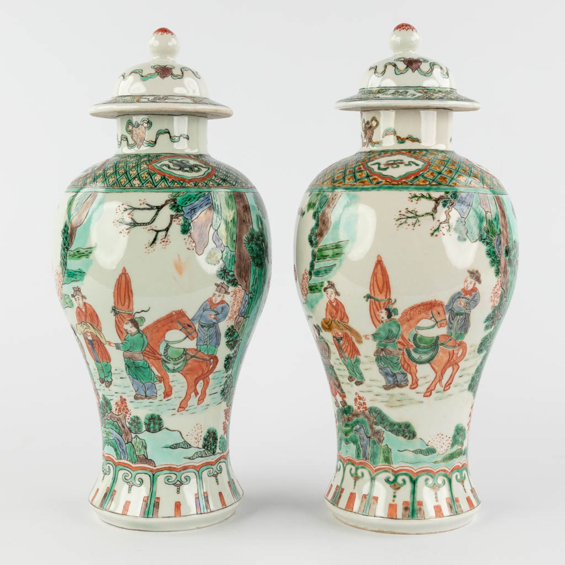 A pair of Chinese Famille Verte with farmers and symbols of happiness. 19th/20th C. (H:29 x D:13 cm)