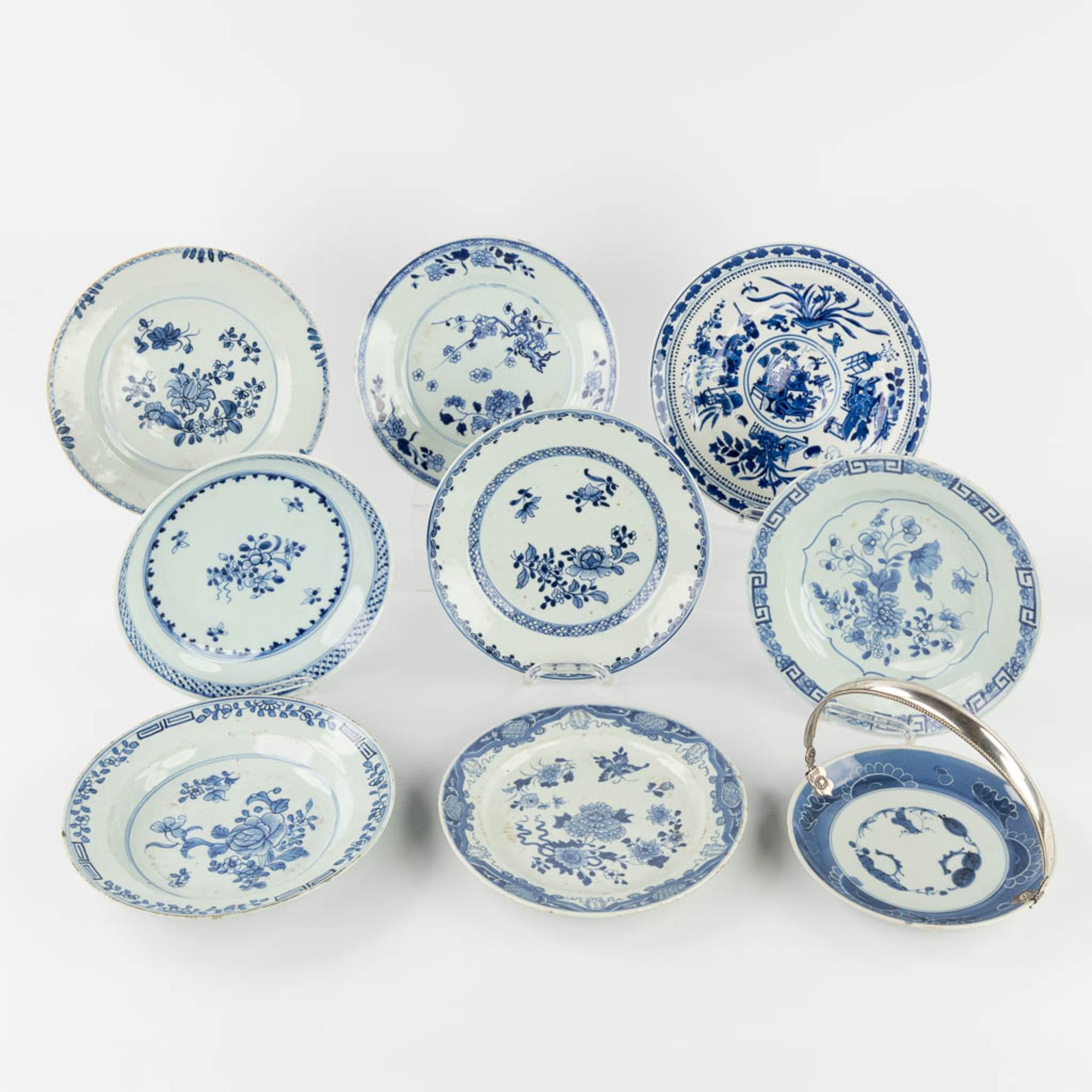 Nine Chinese blue-white decor, of which one has a silver holder. 19th/20th C. (D:23,5 cm)