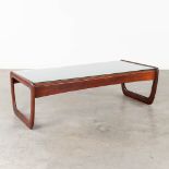 A mid-century coffee table with a glass top, probably teak. (L:30 x W:130 x H:40 cm)