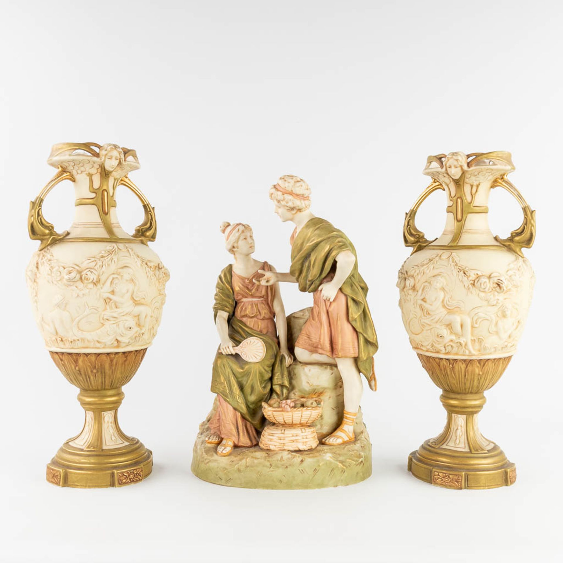 Royal Dux, a three-piece mantle garniture consisting of a statue and two vases. (L:20 x W:28 x H:43