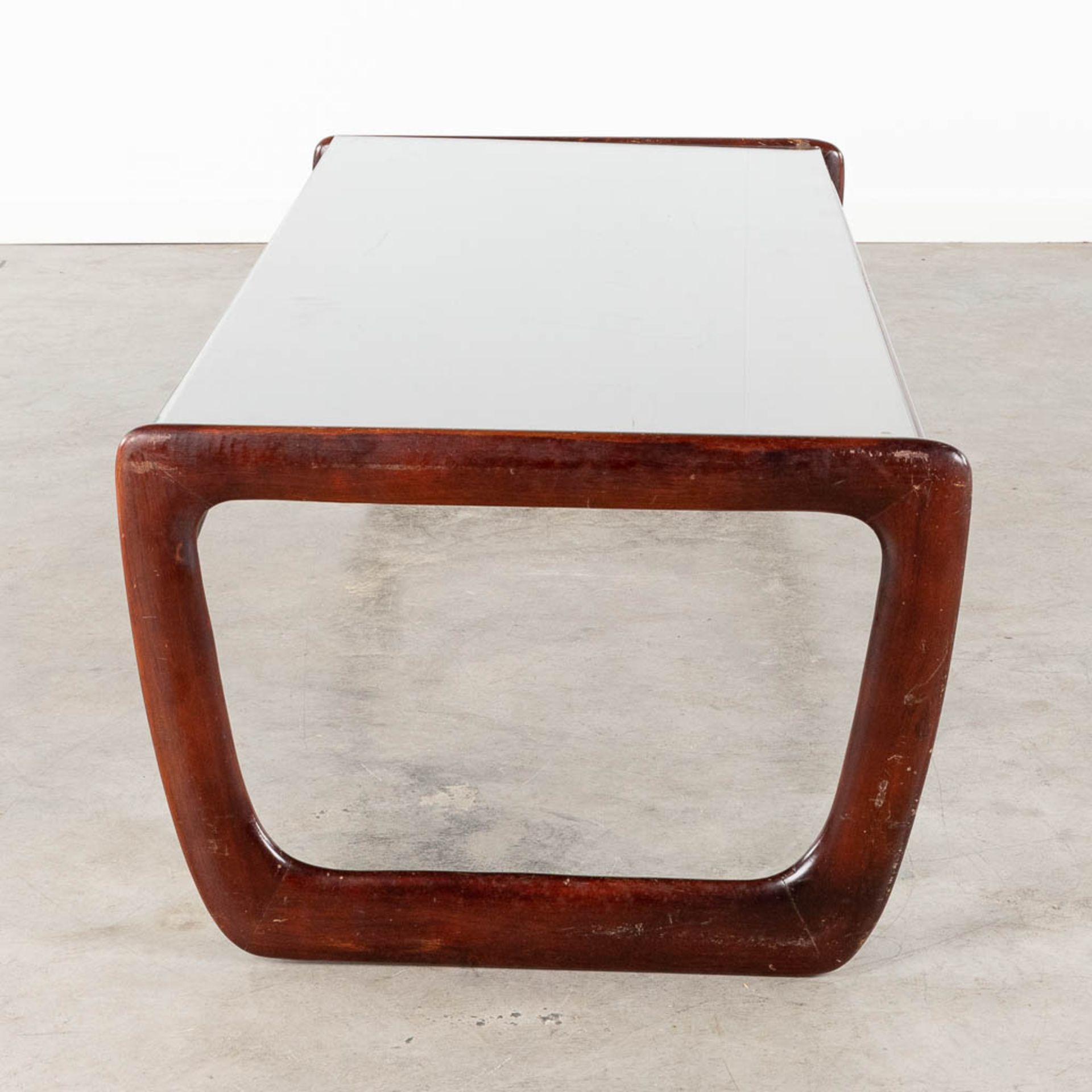 A mid-century coffee table with a glass top, probably teak. (L:30 x W:130 x H:40 cm) - Image 4 of 12