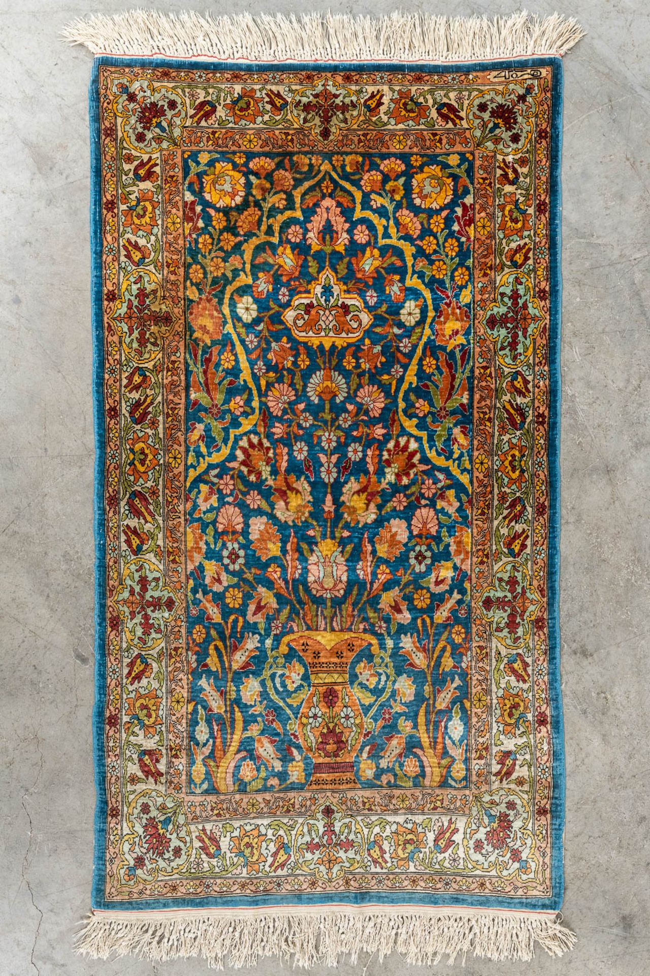 An Oriental hand-made carpet, Ghoum, Signed. (L:108 x W:60 cm)