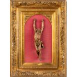 An antique wood-scultpured Corpus Christi, mounted in a gilt frame. (H:63 cm)