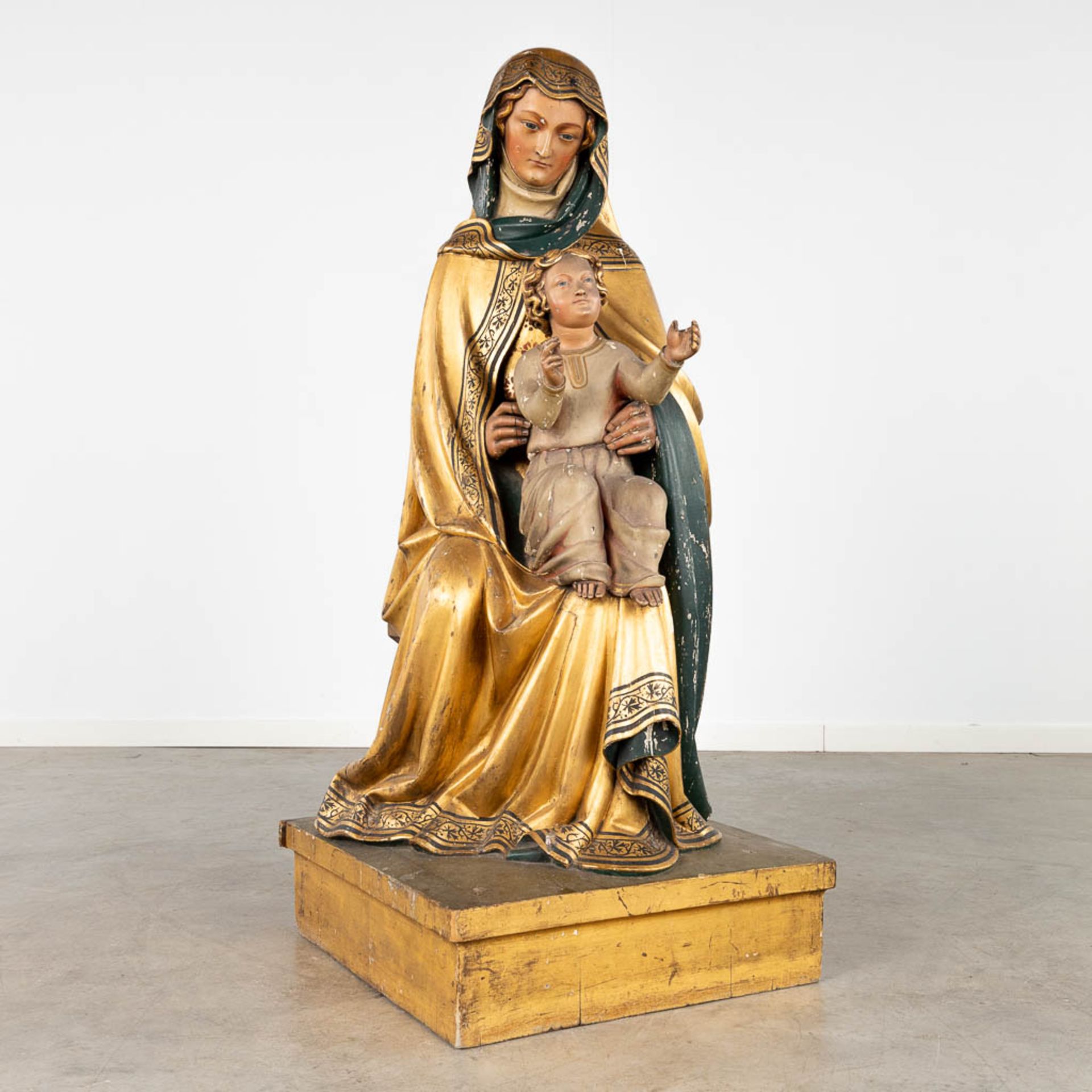 An antique wood-sculptured statue of Saint Anna with child, gilt and polychrome. 18th/19th C. (L:51