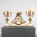 A 3-piece mantle garniture clock and candelabra, gilt bronze on white Carrara marble. 19th C. (L:18