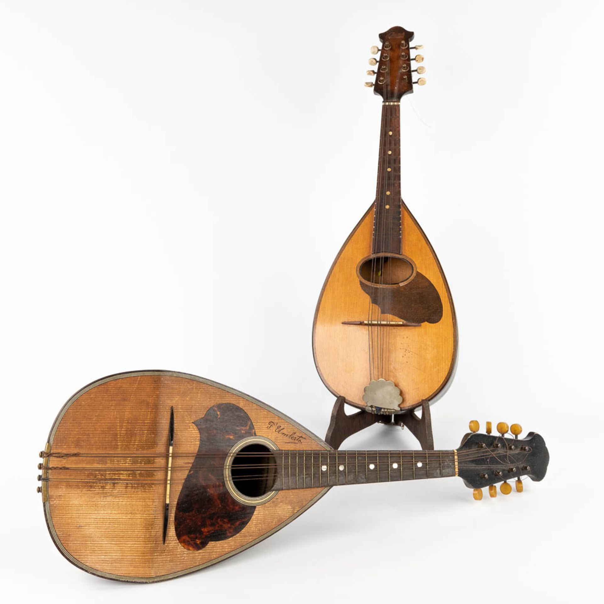 Two mandolines, of which one is marked Fratelli Umberto. (L:20 x W:60 x H:14 cm)