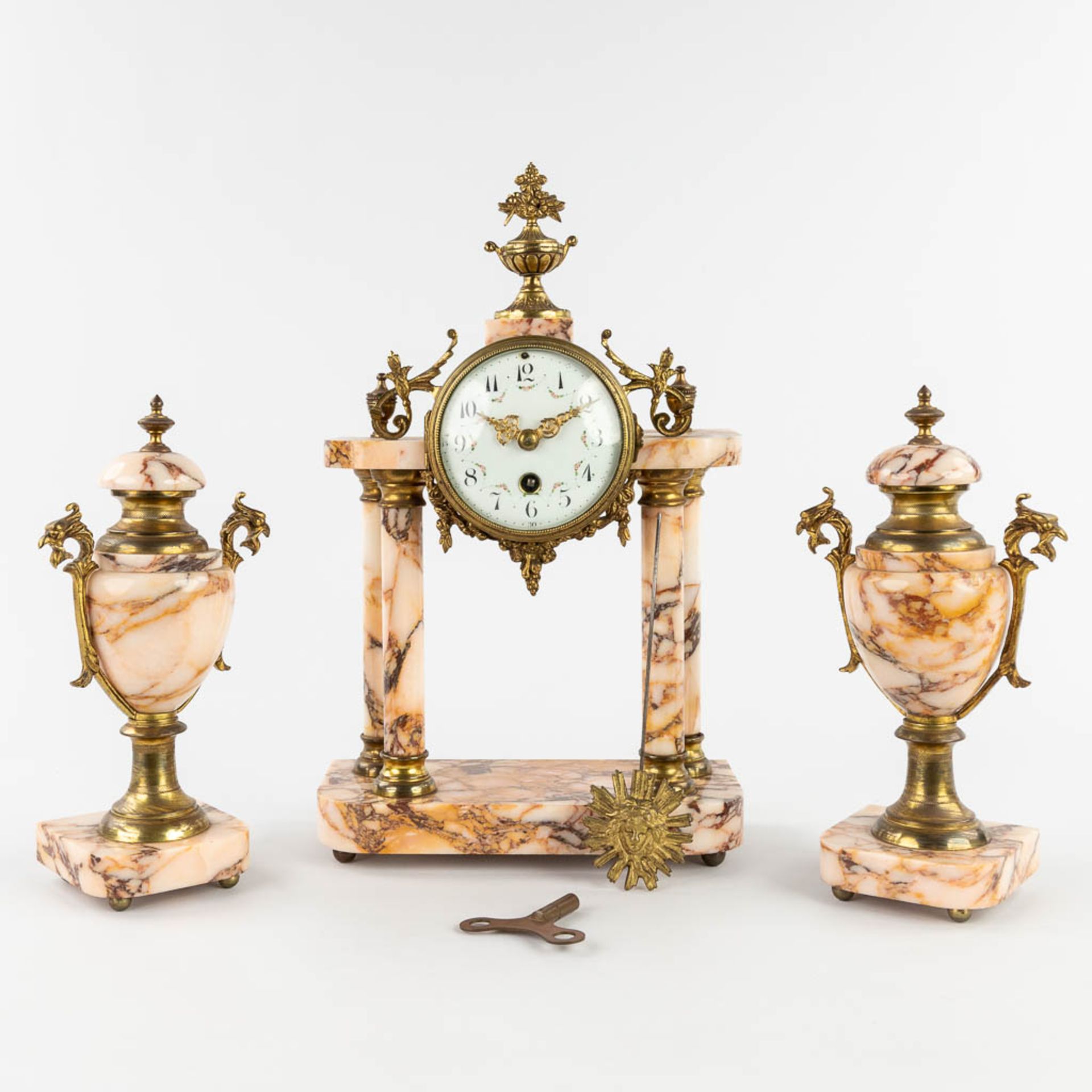 A three-piece mantle garniture, Clock with side pieces, marble mounted with bronze. Circa 1900. (L:1