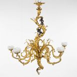 A large chandelier, gilt and patinated bronze in Louis XV style and decorated with putti and a salam