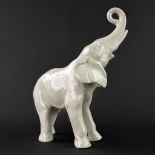 A mid-century ceramic figurine of an elephant. (L:10 x W:22 x H:29 cm)