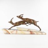 Two running deer, spelter on an onyx base, Art Deco. (L:11 x W:66 x H:31 cm)