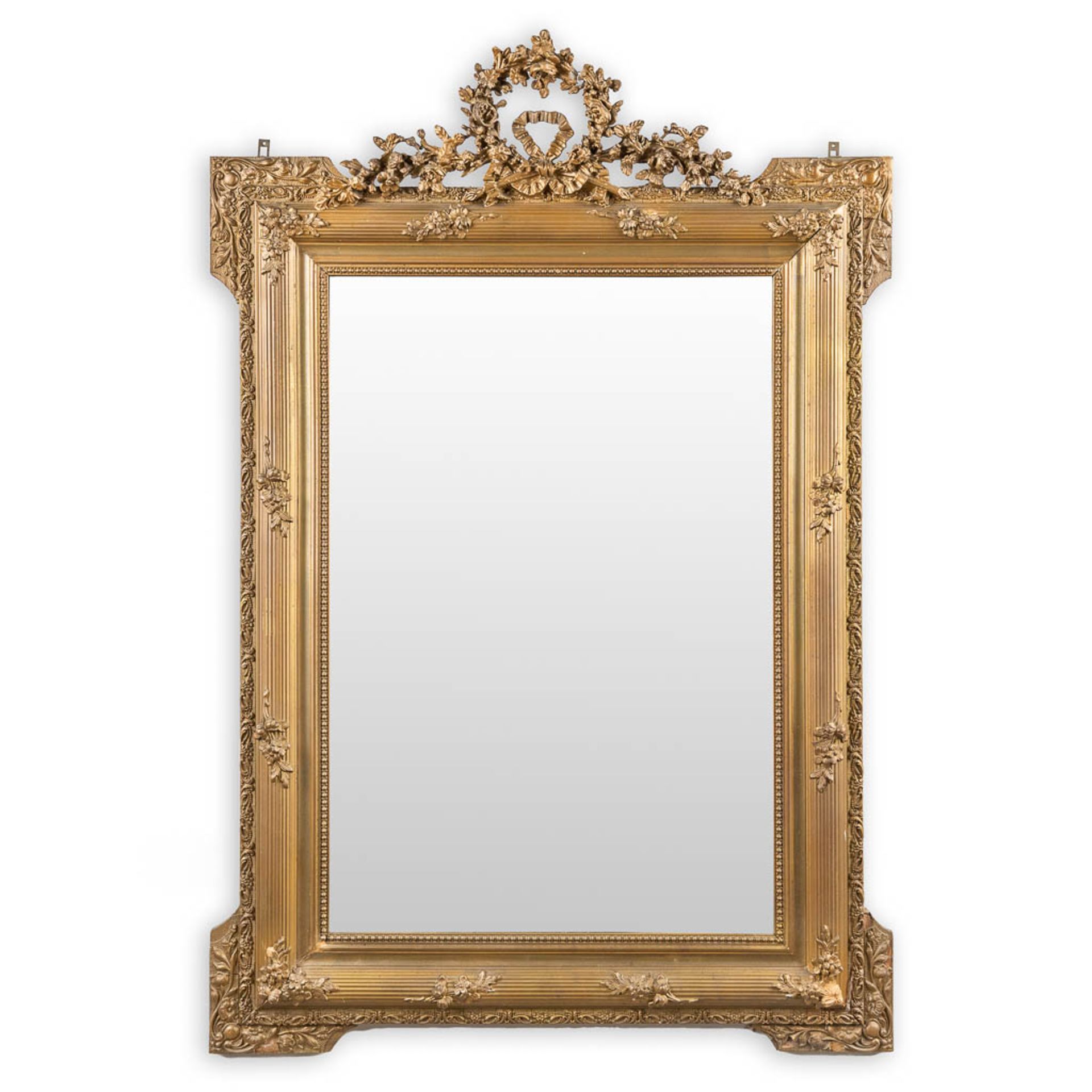 A mirror, decorated with stucco in Louis XVI style. (W:85 x H:125 cm)