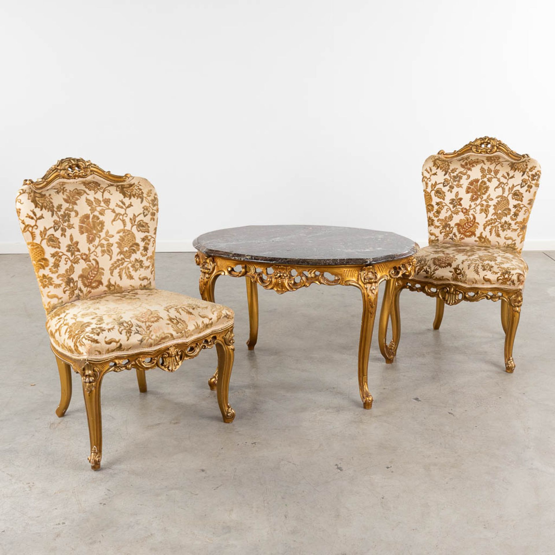 A coffee table, two matching chairs, sculptured wood in Louis XV style. (L:65 x W:85 x H:54 cm)