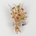 A brooch in the shape of a stack of wheat, with glass cabochons and facetted diamonds. 18kt gold, 13