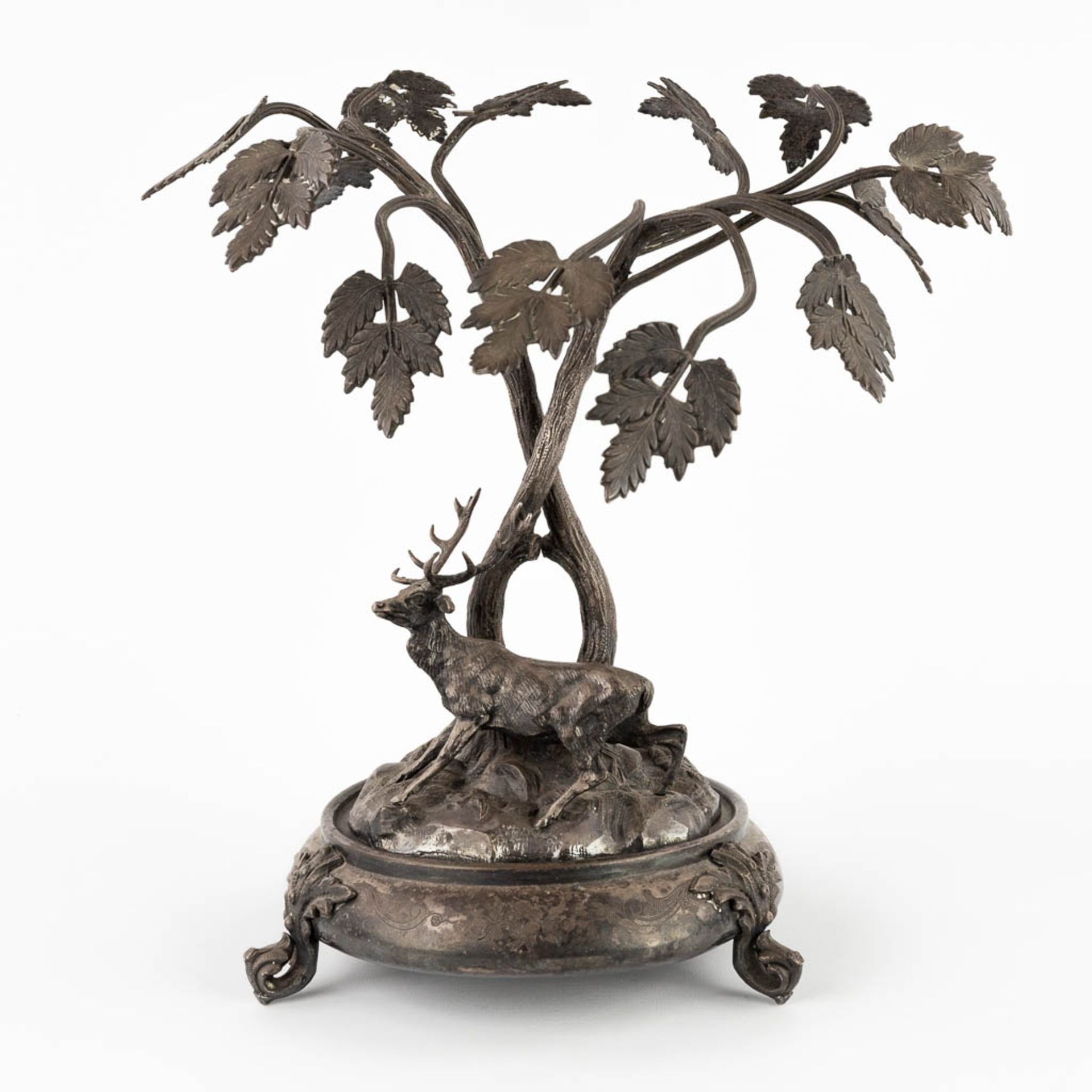 A figurine of a deer, walking under tall trees. Silver-plated bronze. Circa 1900. (D:24 x W:30 x H:3