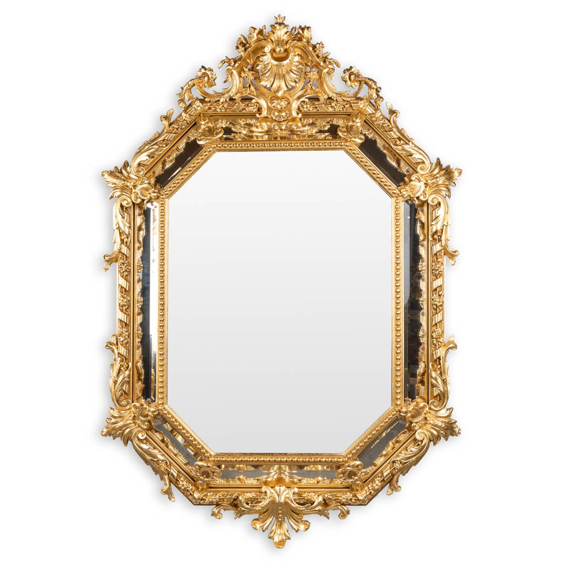 An antique mirror, sculptured gilt stucco and facetted glass, Louis XV style. 19th C. (W:98 x H:140 