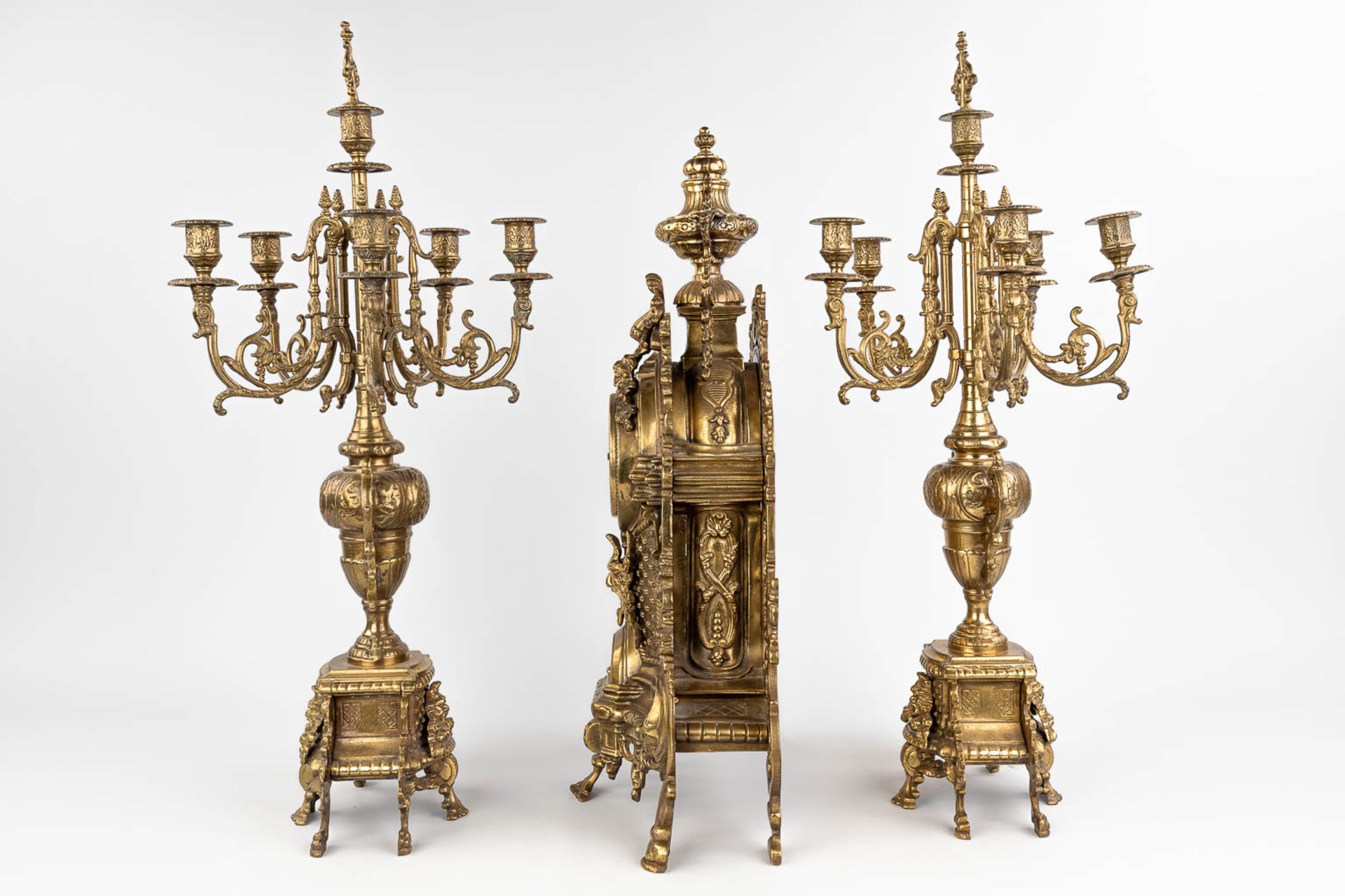 A three-piece mantle garniture consisting of a clock with candelabra, made of bronze. circa 1970. (W - Image 7 of 16