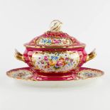A polychrome porcelain tureen with a lid on a stand, hand-painted flower decors, pomegranate finial.