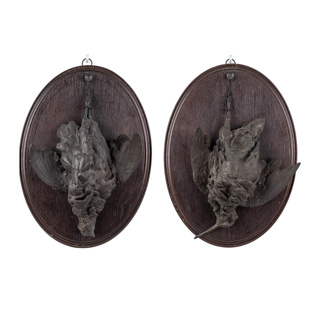 A pair of wall-mounted 'Hunting Trophies', patinated bronze mounted on wood. (D:7 x W:33 x H:46 cm)