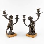 A pair of candelabra, 'Putti and a Faun', patinated bronze on a marble base, France, 19th C. (D:15 x