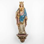 A figurine of Madonna, standing on a plaster console. (W:20 x H:83 cm)