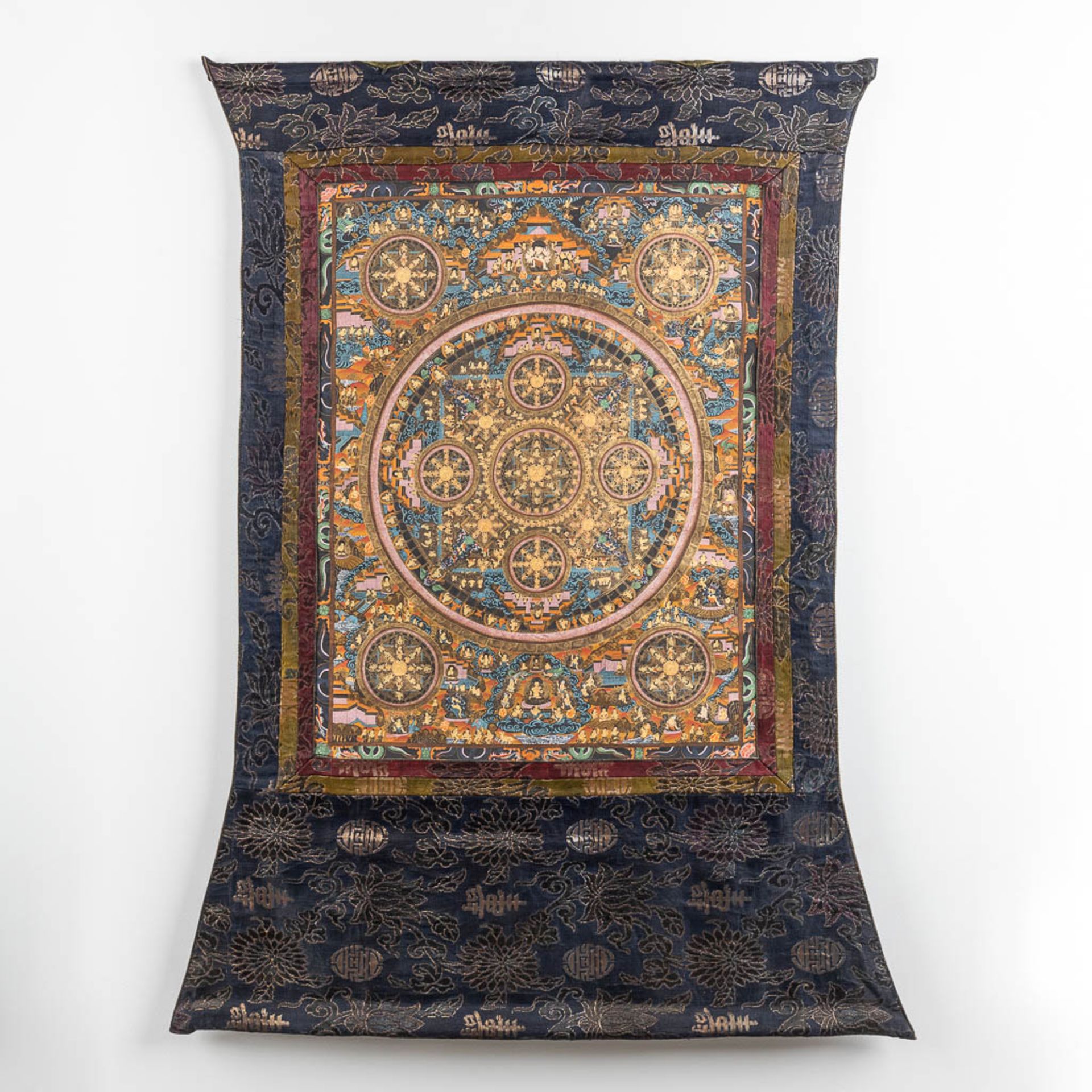 An Eastern Thangka, hand-painted decor on silk. (W:57 x H:74 cm)