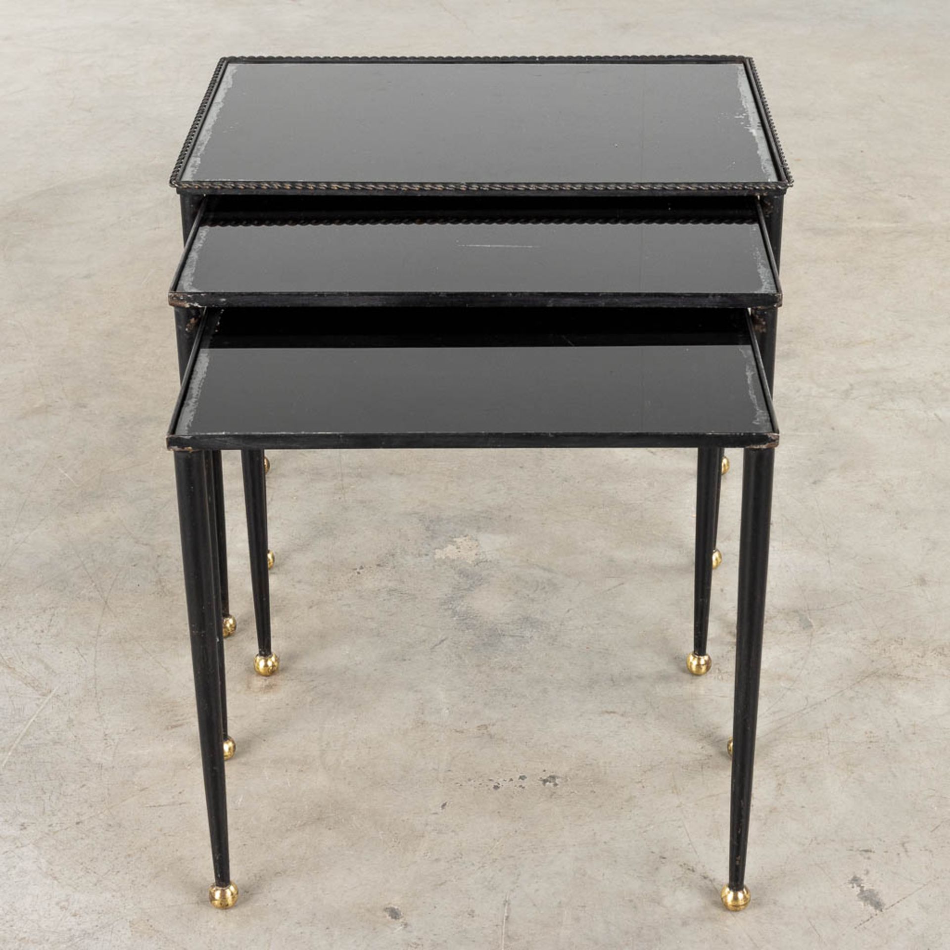 A set of Nesting tables, metal and black tinted glass. 20th C. (D:56 x W:37 x H:50 cm)