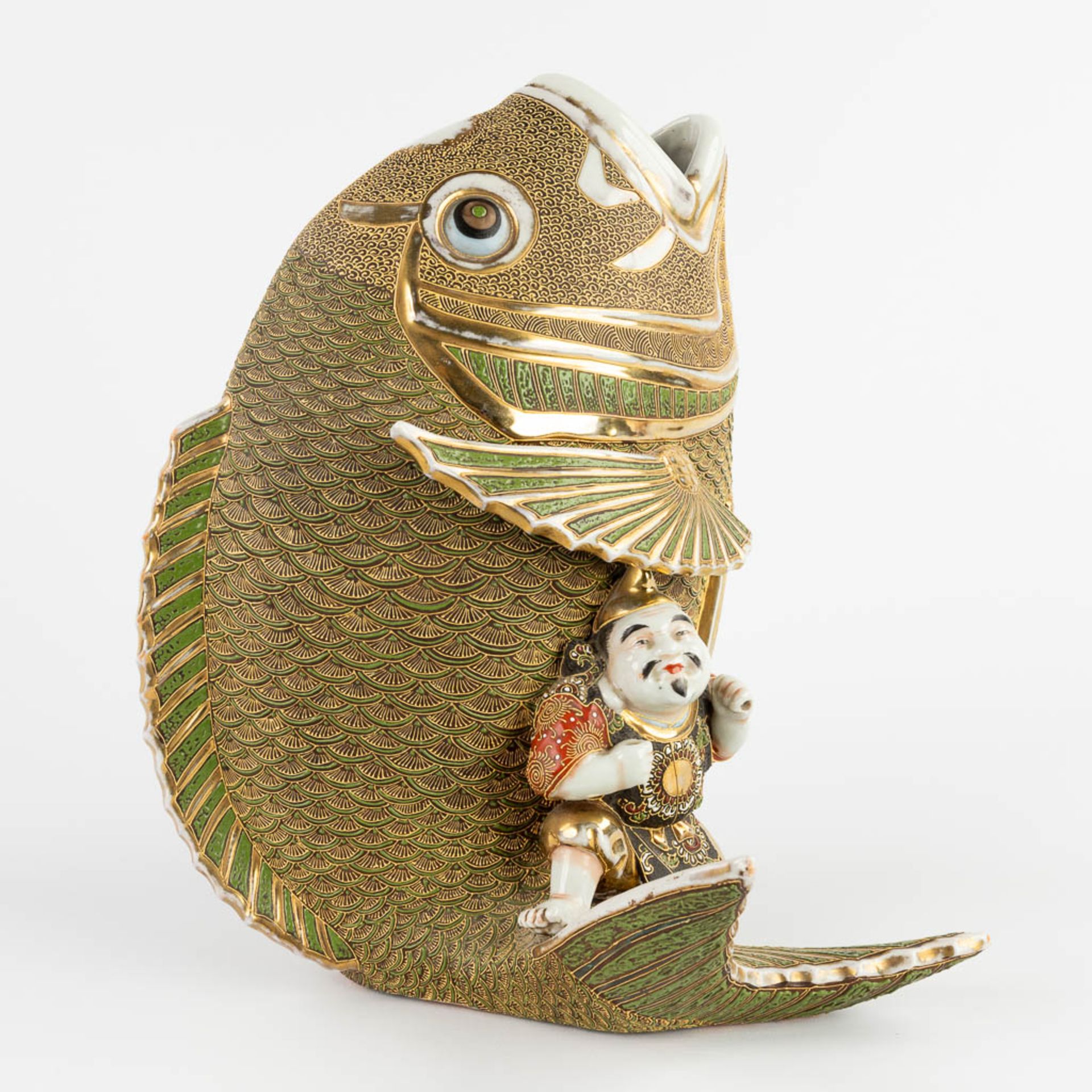 A figurine seaed on a koi, Satsuma stoneware. Meji period. (D:27 x W:26 x H:31 cm)