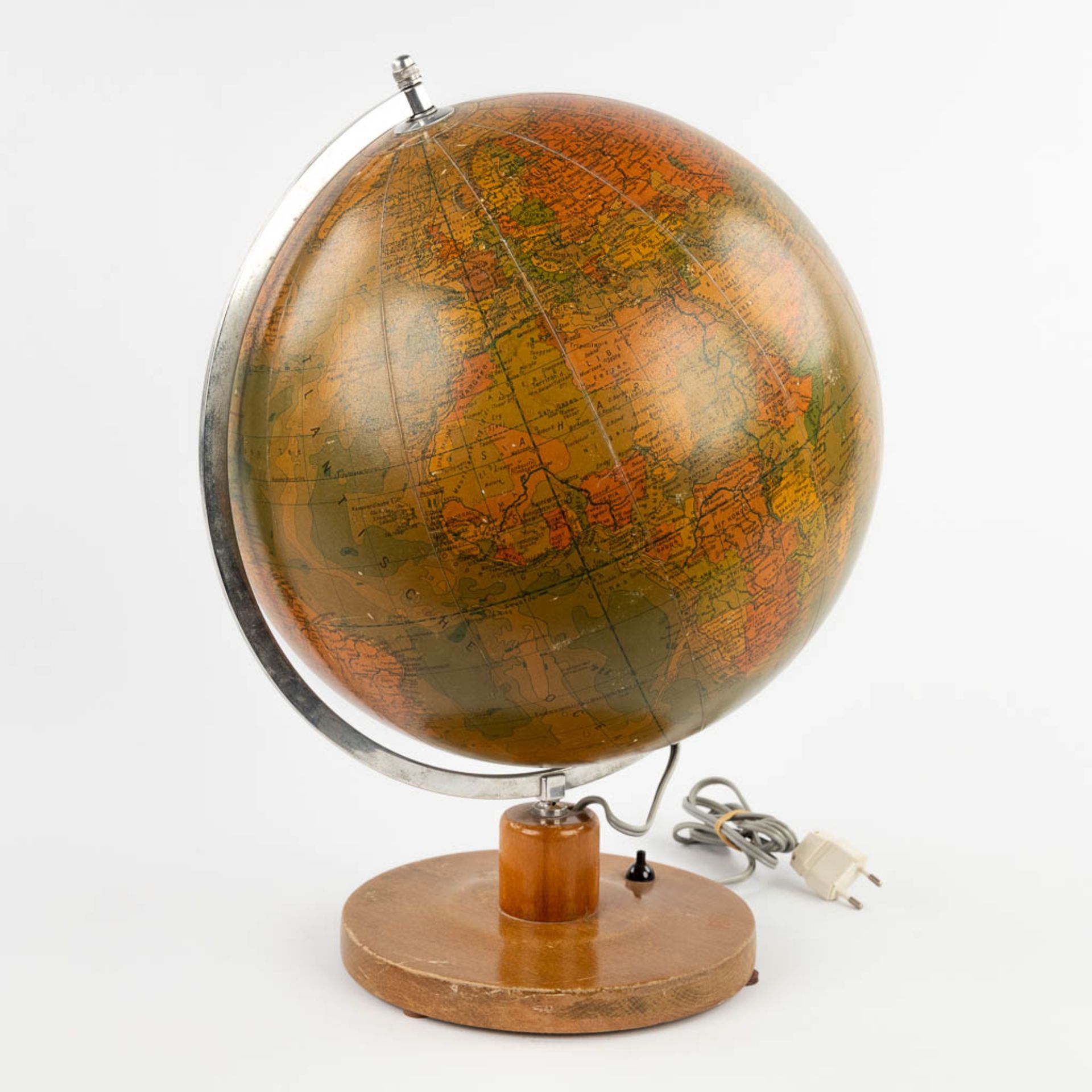 A mid-century globe on a wood base, with illumination. Glass, Circa 1960. (H:46 x D:33 cm)