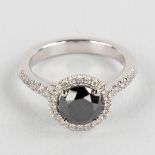 A ring, 18kt white gold with a black diamond, appr. 1.62ct and smaller brilliants, appr. 0.32ct. Rin