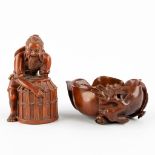 Two Chinese wood sculptures, a fisherman and a brushpot in the shape of a lotus flower. (D:8 x W:8 x