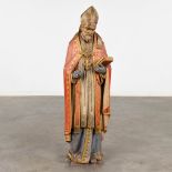 An antique wood sculptured figurine of a saint, original polychromy. 19th C. (D:22 x W:29 x H:90 cm)