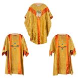 A Chasuble and two dalmatics, decorated with embroideries of 'The Holy Lamb, Basket with bread, The
