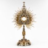 A sunburst monstrance, decorated with images of the stations of the cross and mythological figurines