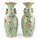 A pair of Chinese celadon ground vases decorated with fauna and flora. 19th/20th C. (H:61 x D:25 cm)