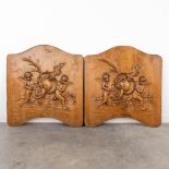 A pair of sculptured panels with images of putti. Circa 1900. (W:70 x H:75 cm)