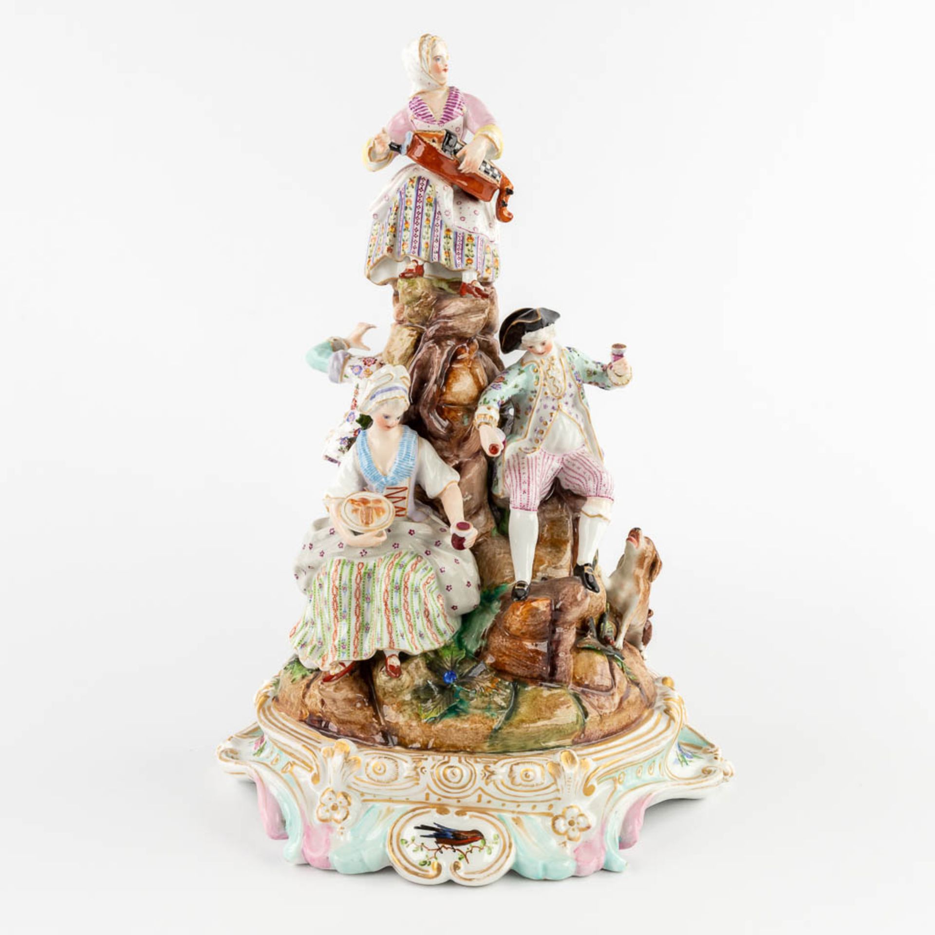 A large polychrome porcelain group with a 'Hurdy Gurdy'. 19th C. (D:22 x W:25 x H:34 cm)