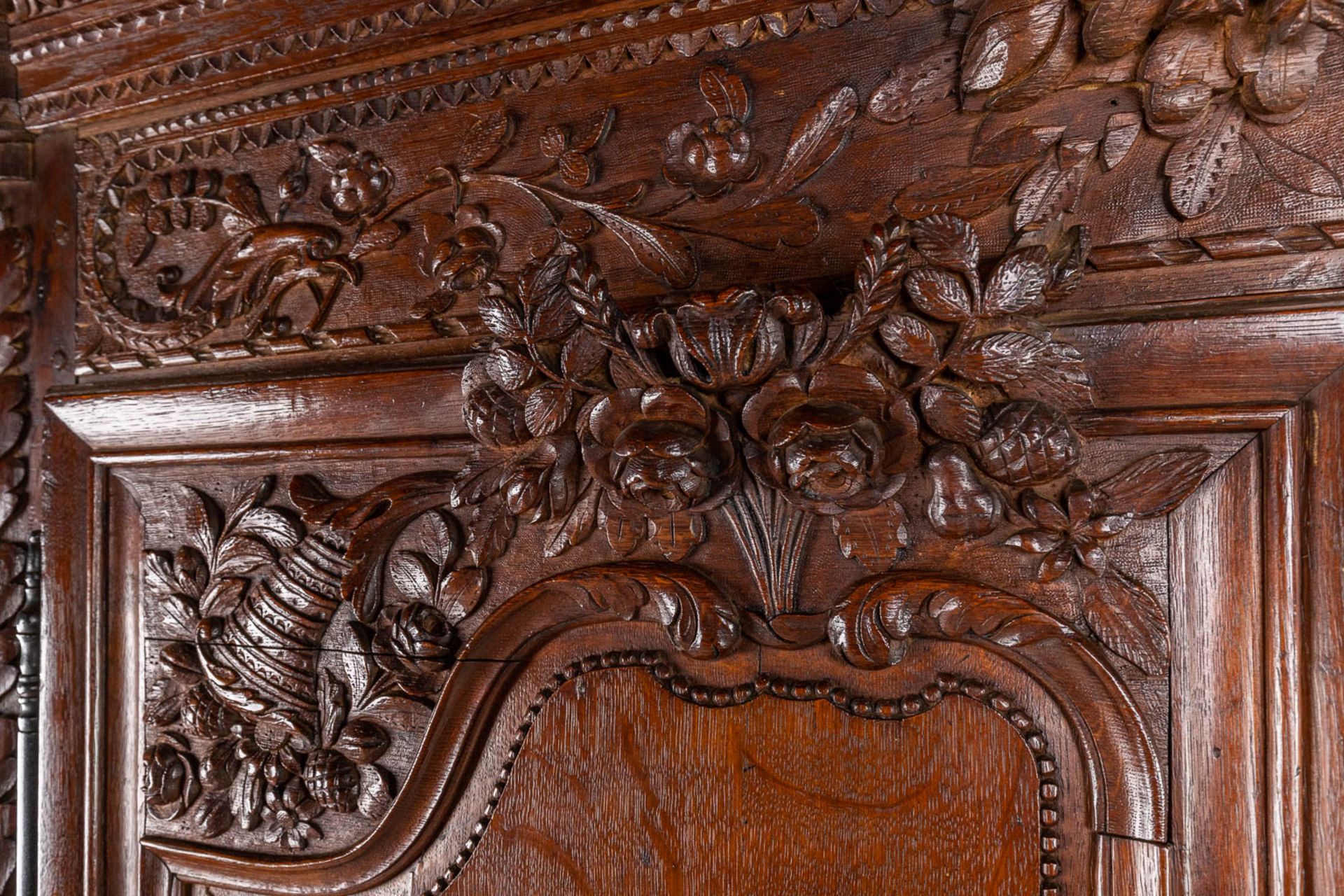 A richly sculptured and antique Normandy high cabinet, Armoire. France, 18th C. (D:68 x W:175 x H:23 - Image 14 of 21