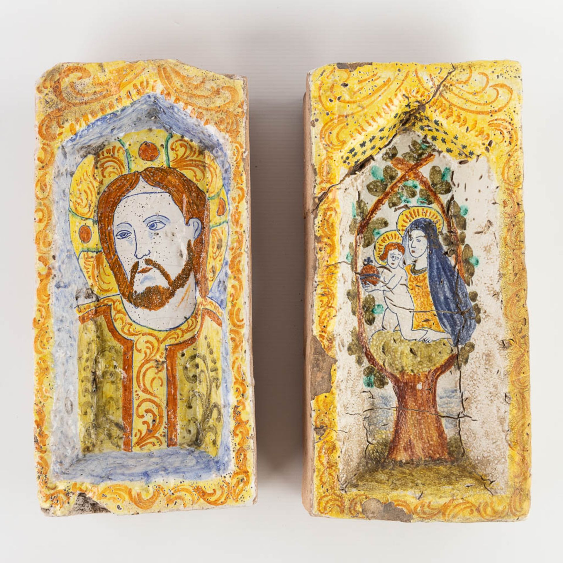 Two terracotta nices/recesses, terracotta with a polychrome image of Jesus and Madonna with a Child.