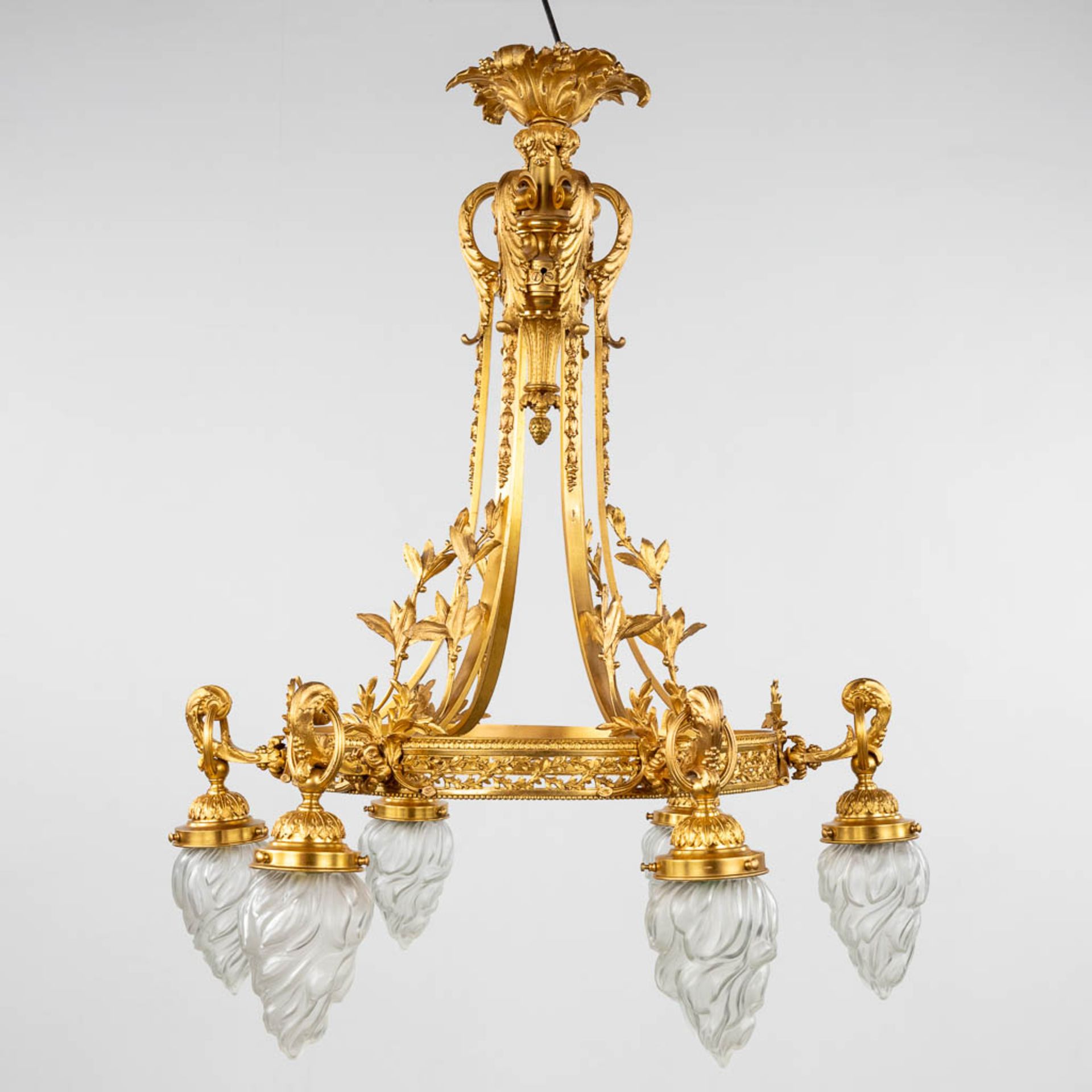 A large ceiling lamp or chandelier, gilt bronze with glass 'flambeau' shades. Circa 1900. (H:90 x D: