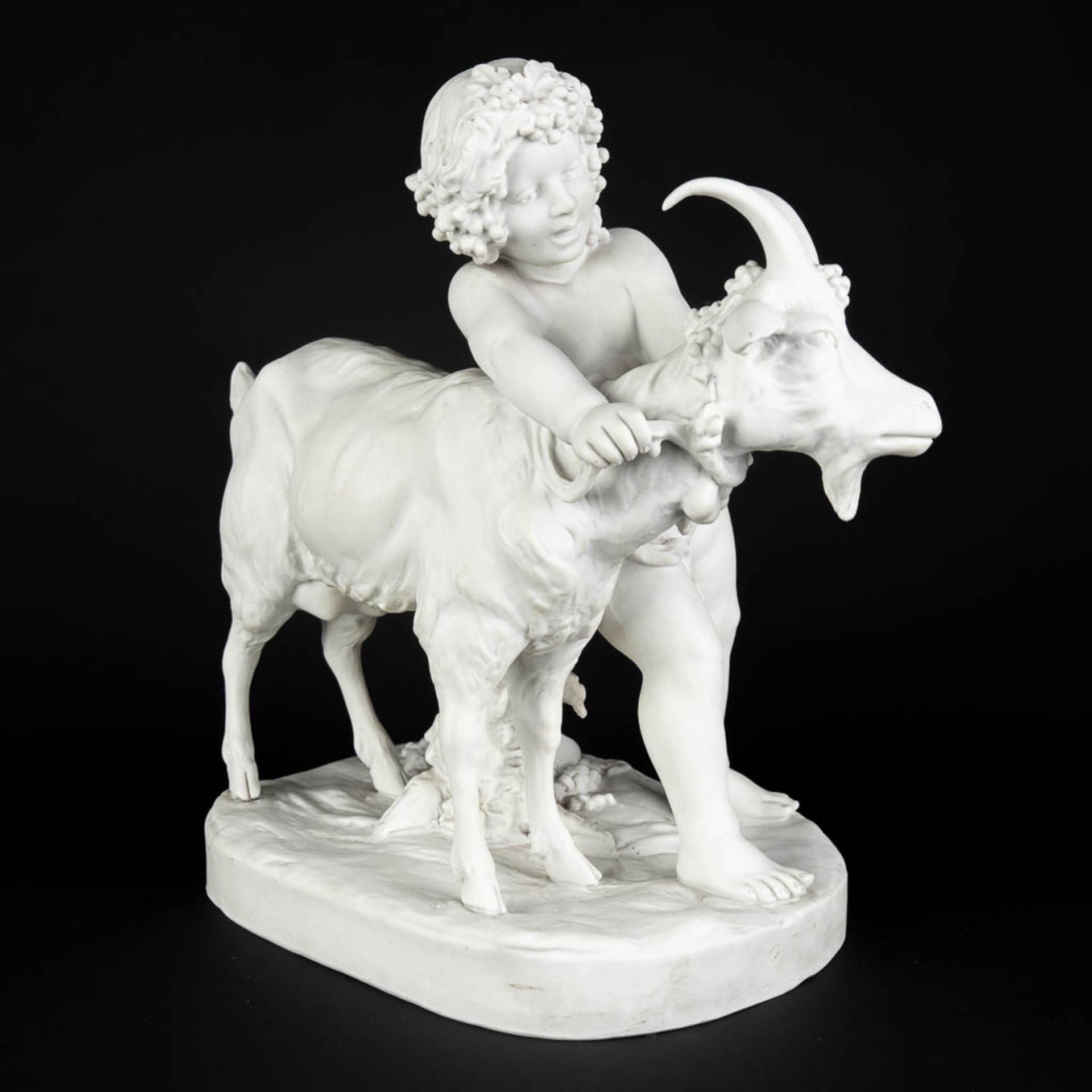 FAGOTTO (XIX-XX) 'Child with a ram' Bisque porcelain, marked Sèvres, Paris. (D:19 x W:33 x H:32 cm)