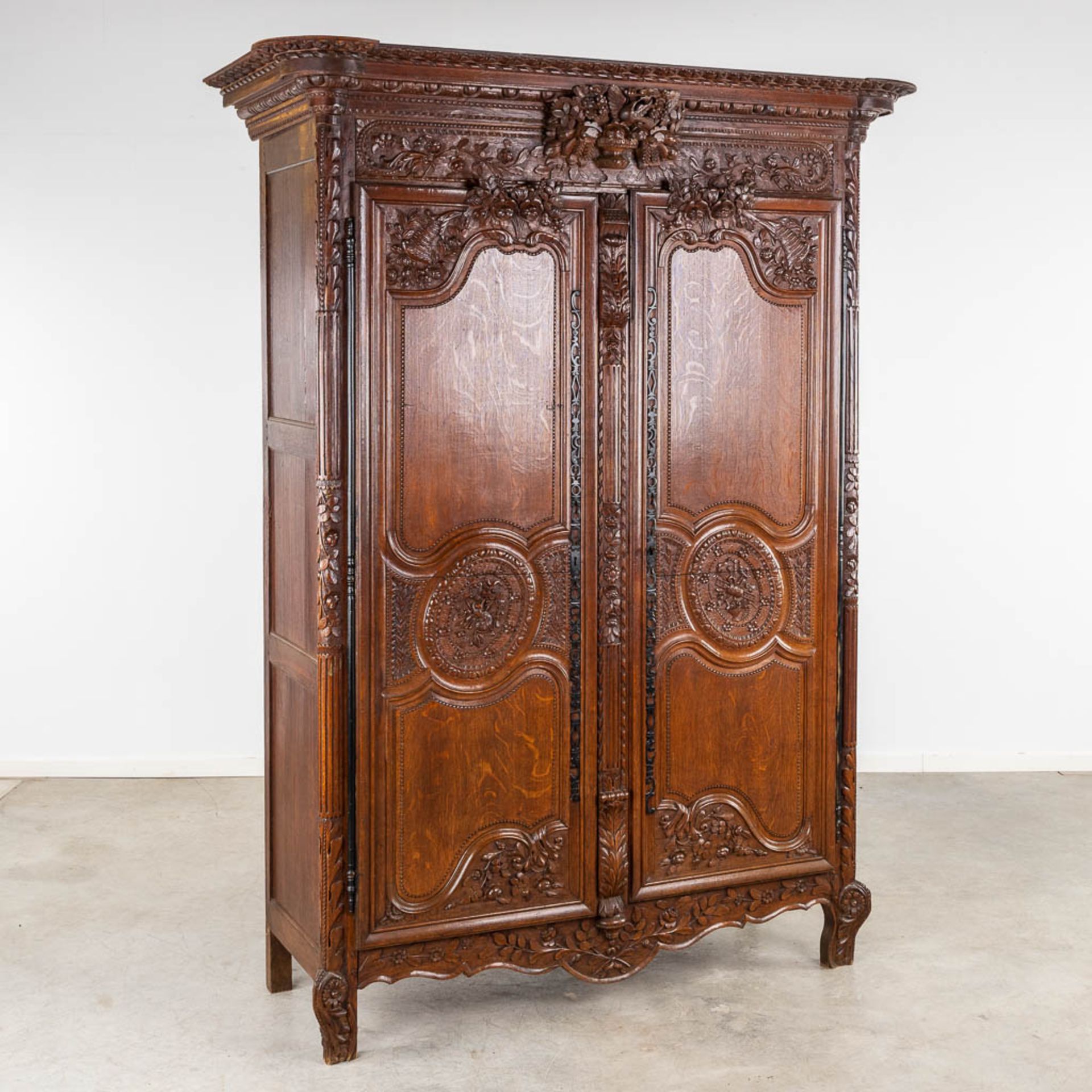 A richly sculptured and antique Normandy high cabinet, Armoire. France, 18th C. (D:68 x W:175 x H:23