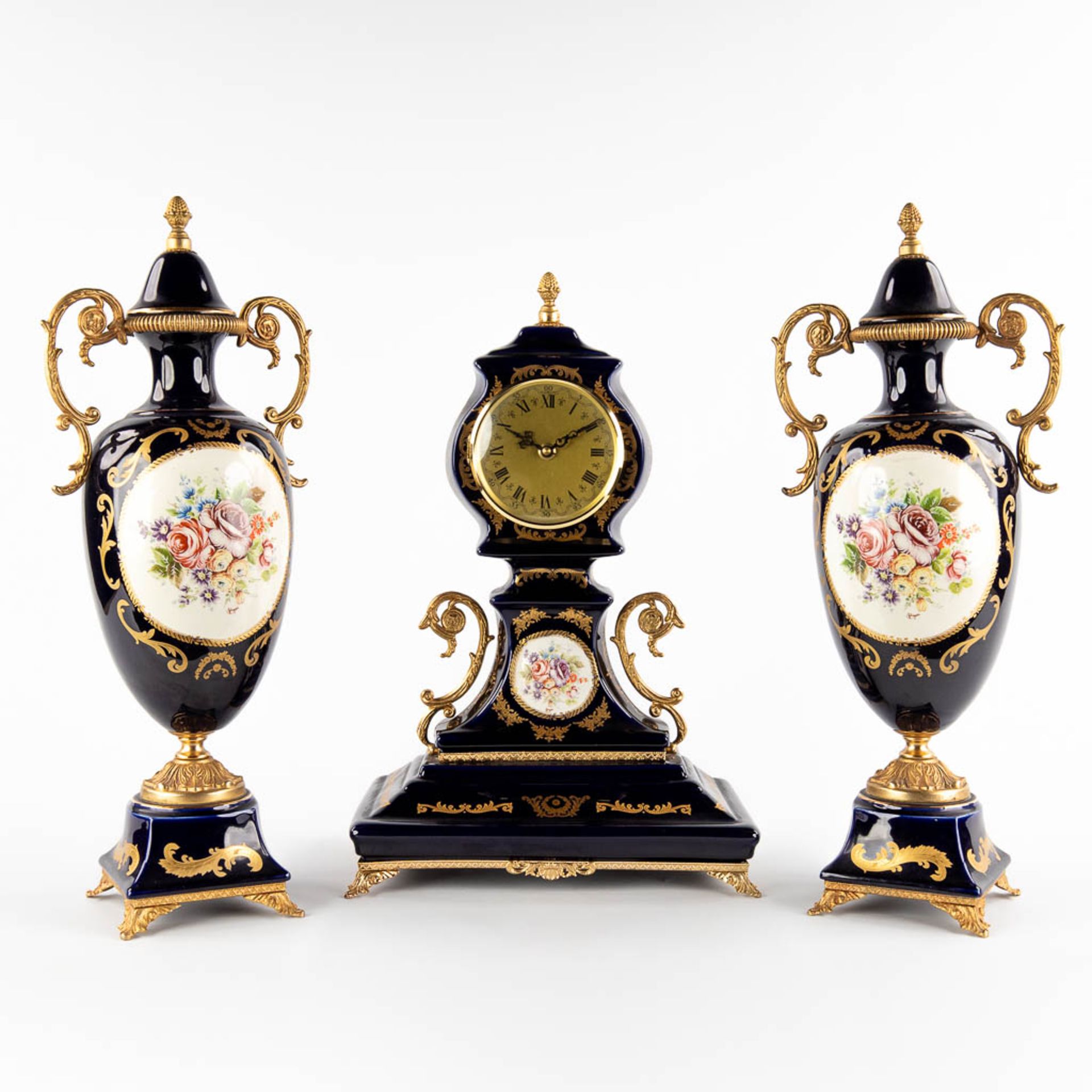 A three-piece mantle garniture clock with side pieces, cobalt blue porcelain mounted with bronze. Sè