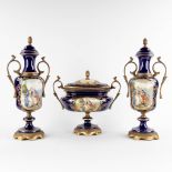 A three-piece mantle garniture, cobalt blue mounted with bronze with a Romantic decor. Marked Limoge