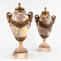 A pair of cassolettes, marble mounted with bronze, decorated with garlands and ram's heads. Circa 19