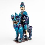 An Oriental temple guard, blue glazed faience. (D:18 x W:34 x H:54 cm)