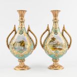 A pair of polychrome porcelain vases with landscape- and flowerdecor. 19th C. (H:26,5 x D:14 cm)