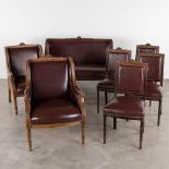 A 7-piece salon suite, sculptured wood uphostered with leather in Louis XVI style. (D:66 x W:134 x H