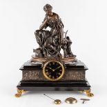 A mantle clock, marble mounted with bronze and a patinated bronze figurine. 19th C. (D:22,5 x W:42 x